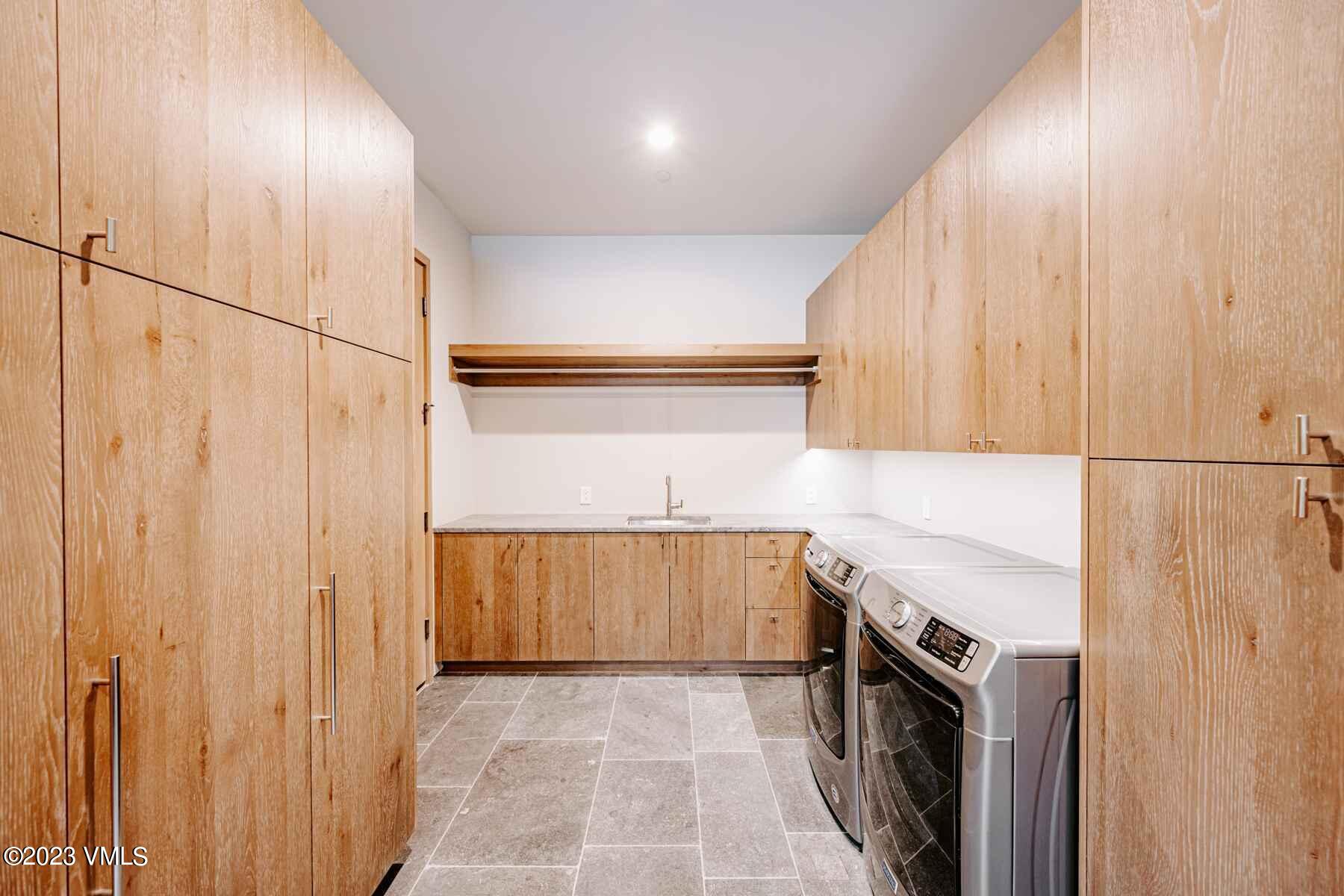 1033 Homestake Circle Vail, CO 81657 - Photo 17 of 30 a kitchen with a sink a washer and dryer