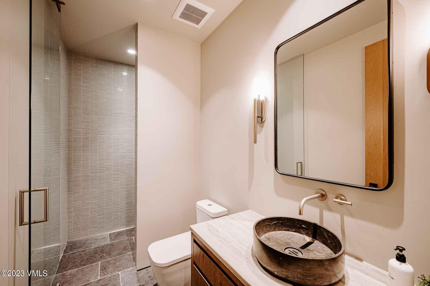 1033 Homestake Circle Vail, CO 81657 - Photo 19 of 30 a bathroom with a granite countertop sink and a mirror
