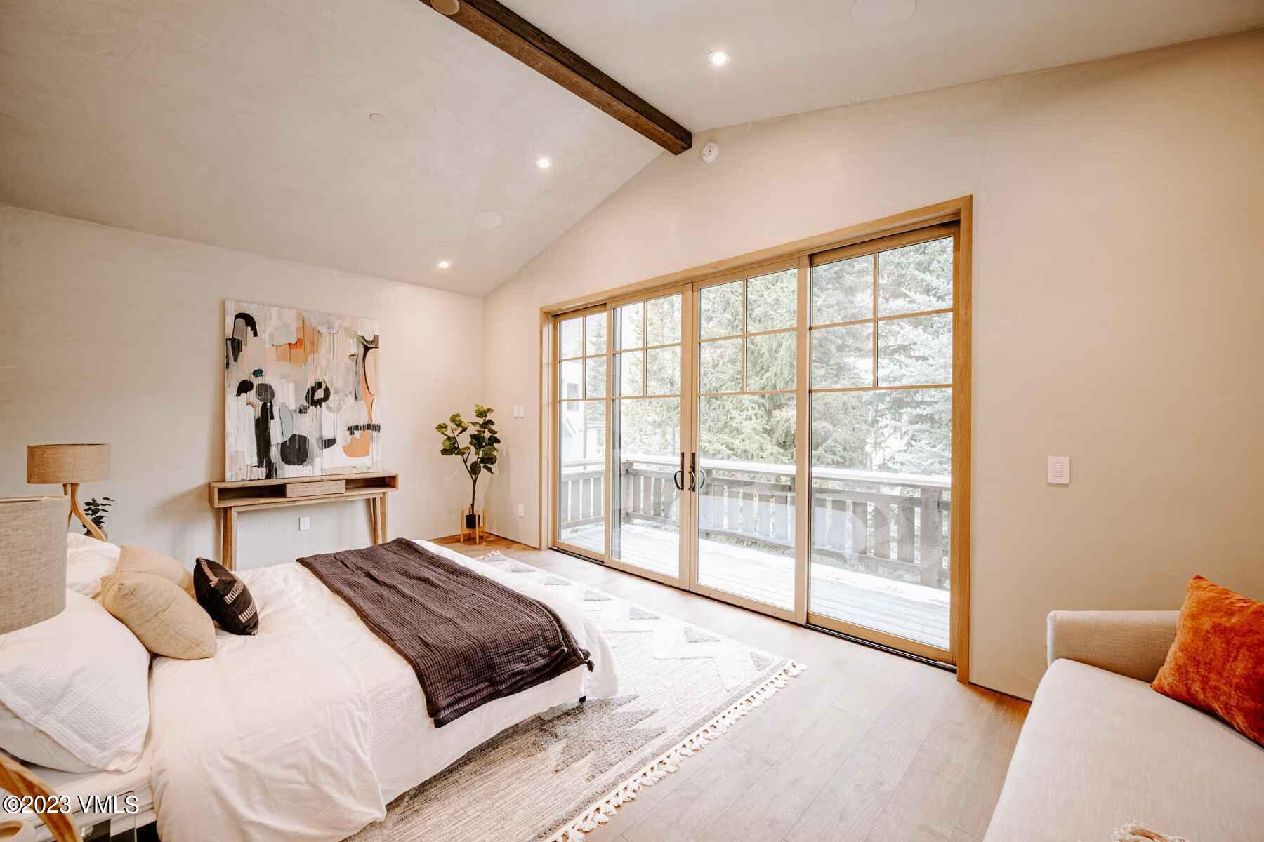 1033 Homestake Circle Vail, CO 81657 - Photo 22 of 30 a bedroom with a large bed and a large window