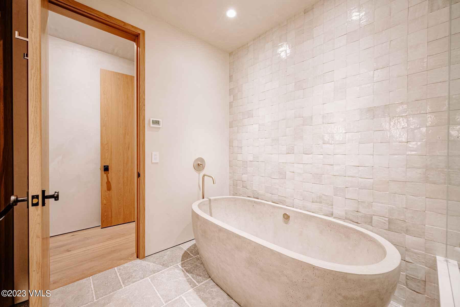 1033 Homestake Circle Vail, CO 81657 - Photo 27 of 30 a bathroom with a bathtub and shower