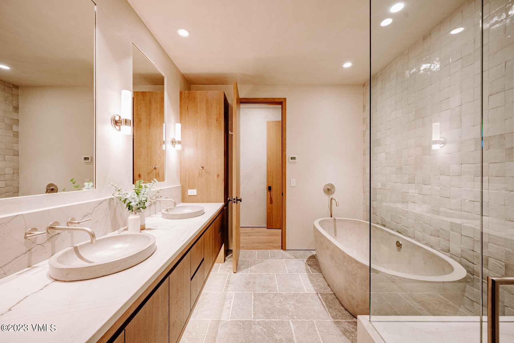 1033 Homestake Circle Vail, CO 81657 - Photo 28 of 30 a bathroom with a tub sink and mirror