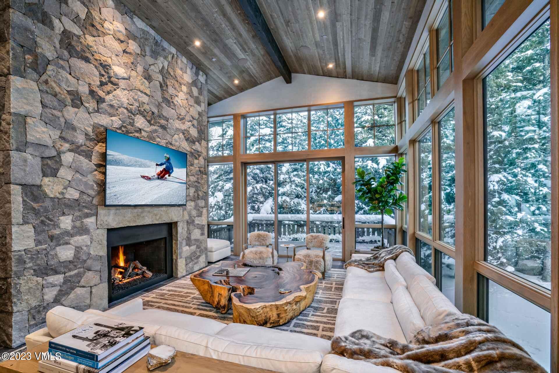1033 Homestake Circle Vail, CO 81657 - Photo 3 of 30 a living room with furniture large window and a fireplace