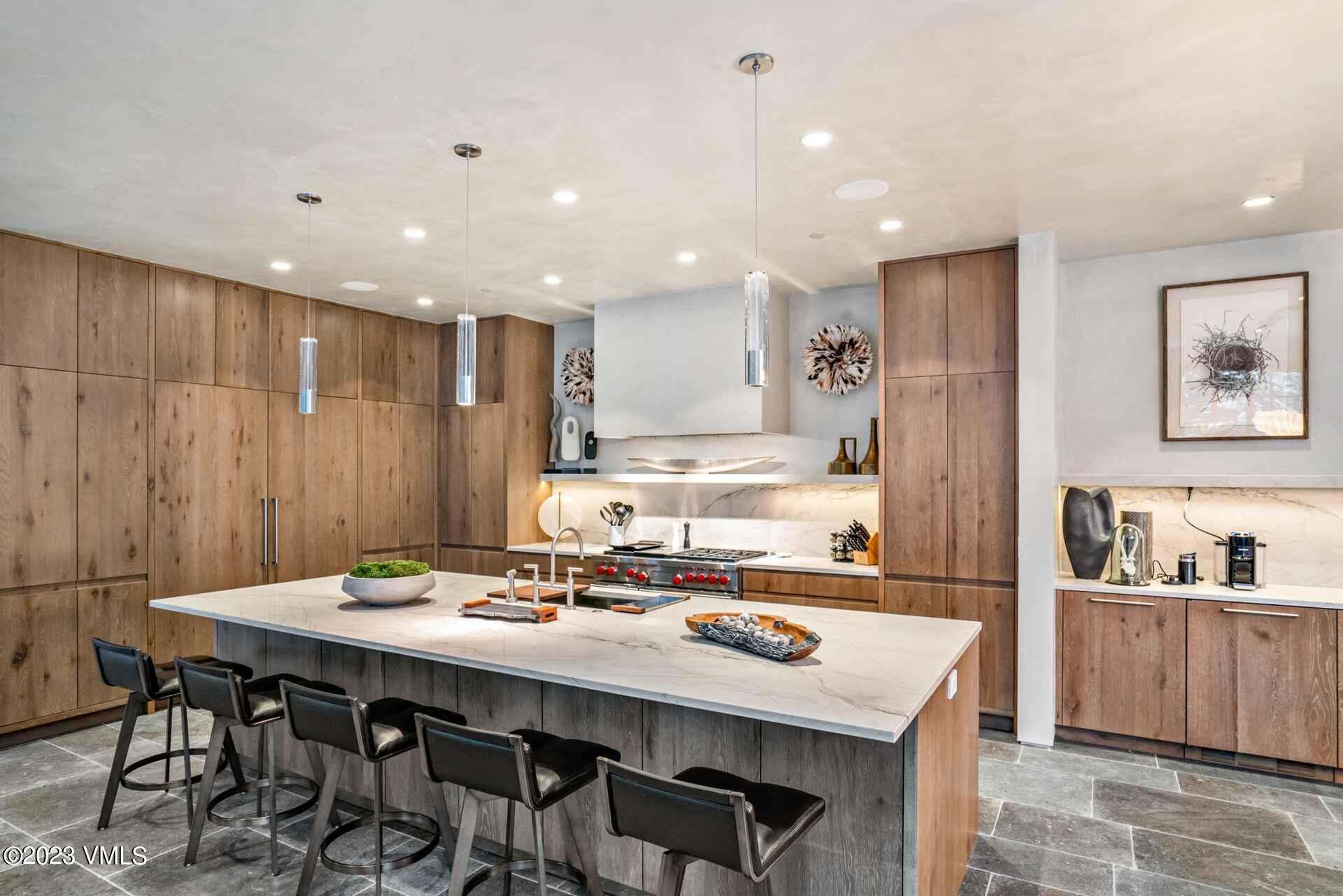 1033 Homestake Circle Vail, CO 81657 - Photo 7 of 30 a kitchen with a dining table chairs and refrigerator