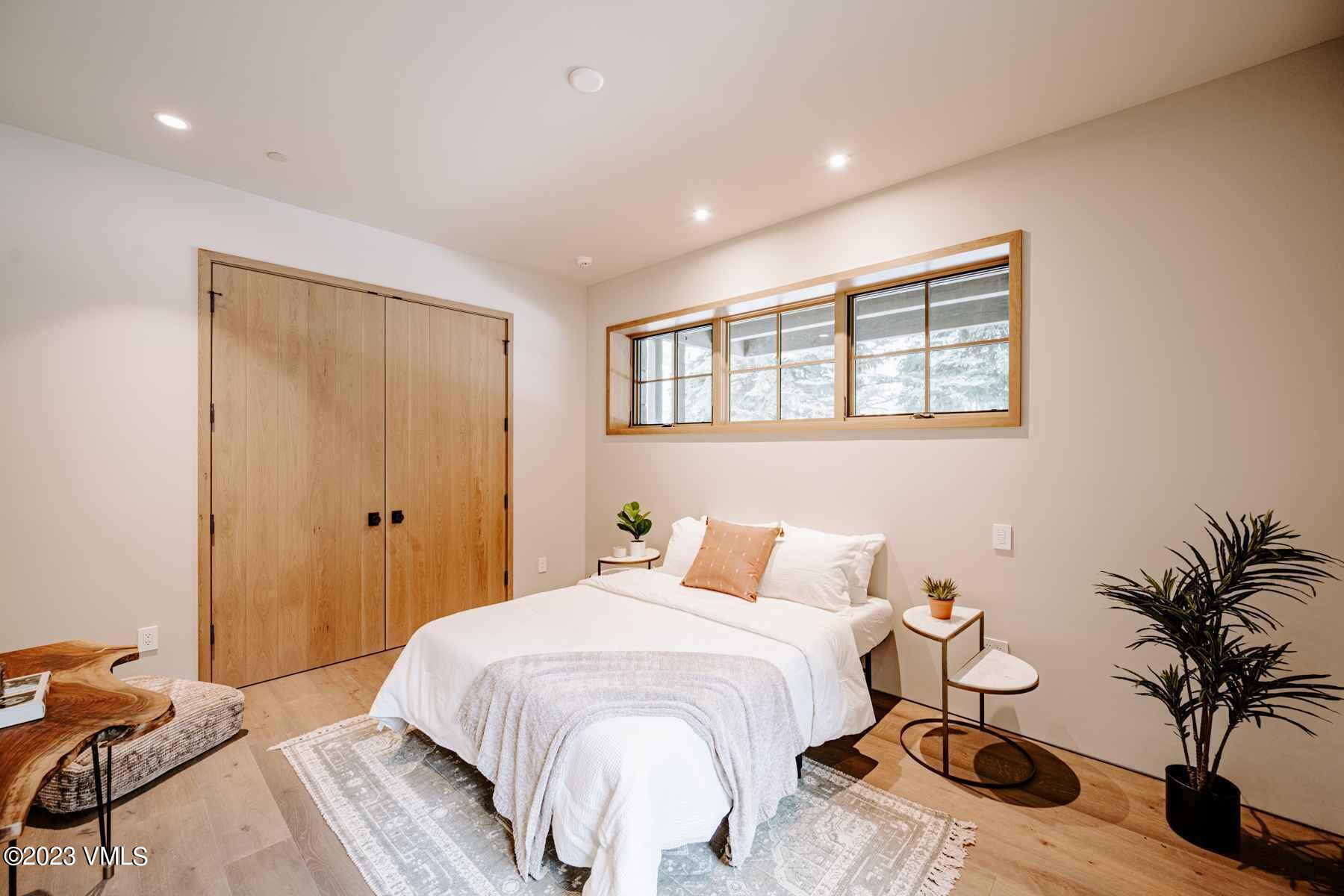 1033 Homestake Circle Vail, CO 81657 - Photo 10 of 30 a bedroom with a bed and a potted plant