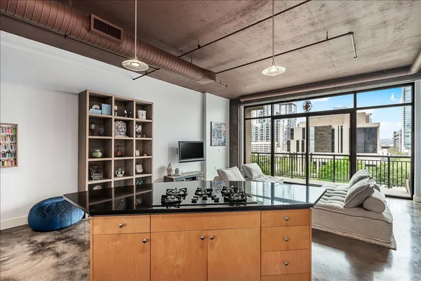 a living room with furniture and a floor to ceiling window