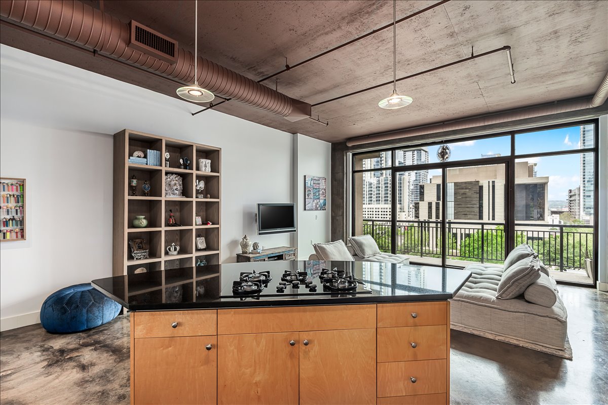 311 West 5th Street, Unit 703 Austin, TX 78701 - Photo 13 of 30 a living room with furniture and a floor to ceiling window