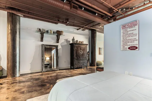 a bedroom with a bed and a mirror