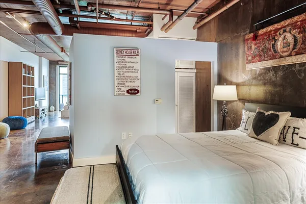 a bedroom with a bed and a couch