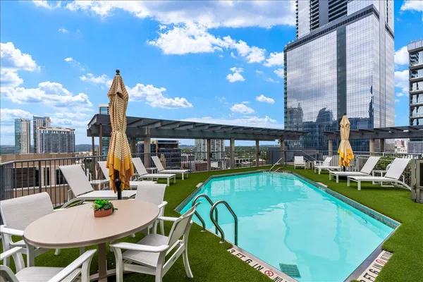 a view of a swimming pool with outdoor seating