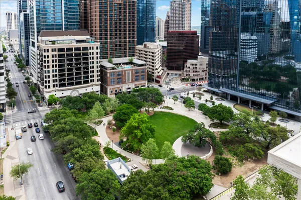 an aerial view of a building with garden space and street view