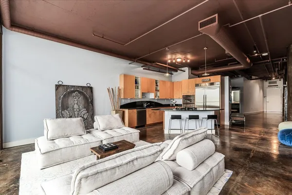 a living room with furniture and kitchen view