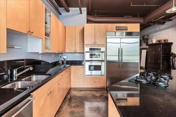 a kitchen with refrigerator and window