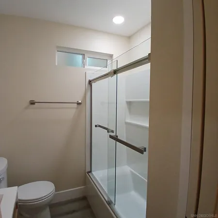 a bathroom with a shower and a toilet