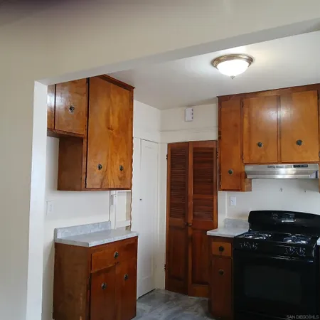 a kitchen with stainless steel appliances granite countertop a stove and a refrigerator