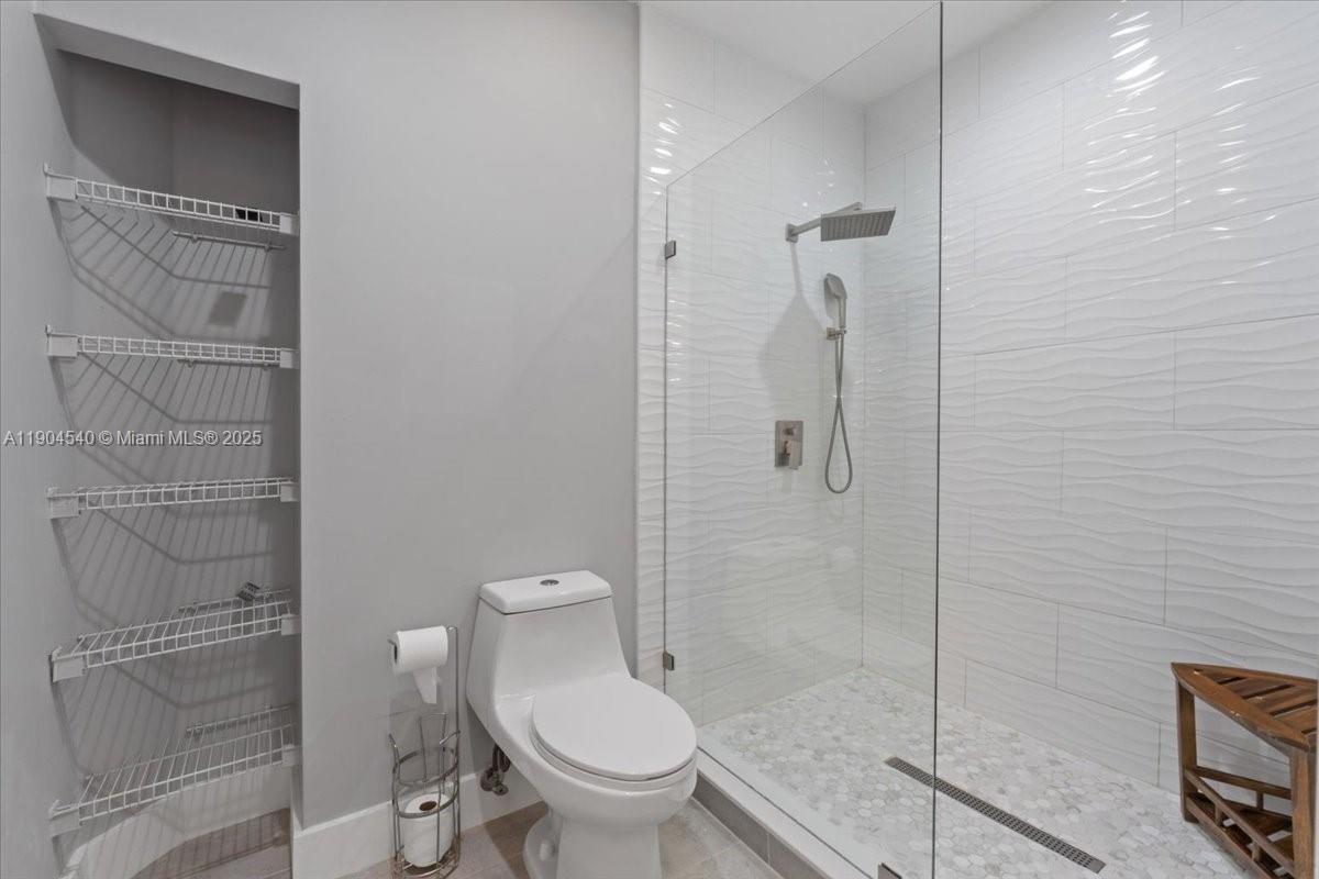 12720 Southwest 49th Court Miramar, FL 33027 - Photo 12 of 26 a bathroom with a shower and a toilet