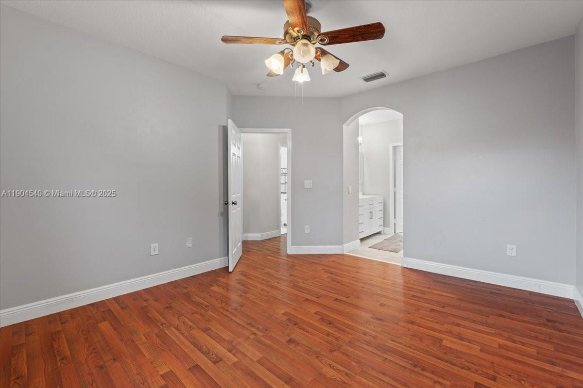 12720 Southwest 49th Court Miramar, FL 33027 - Photo 13 of 26 wooden floor in an empty room with a window