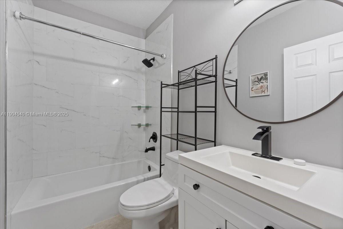 12720 Southwest 49th Court Miramar, FL 33027 - Photo 15 of 26 a bathroom with a sink a toilet and shower