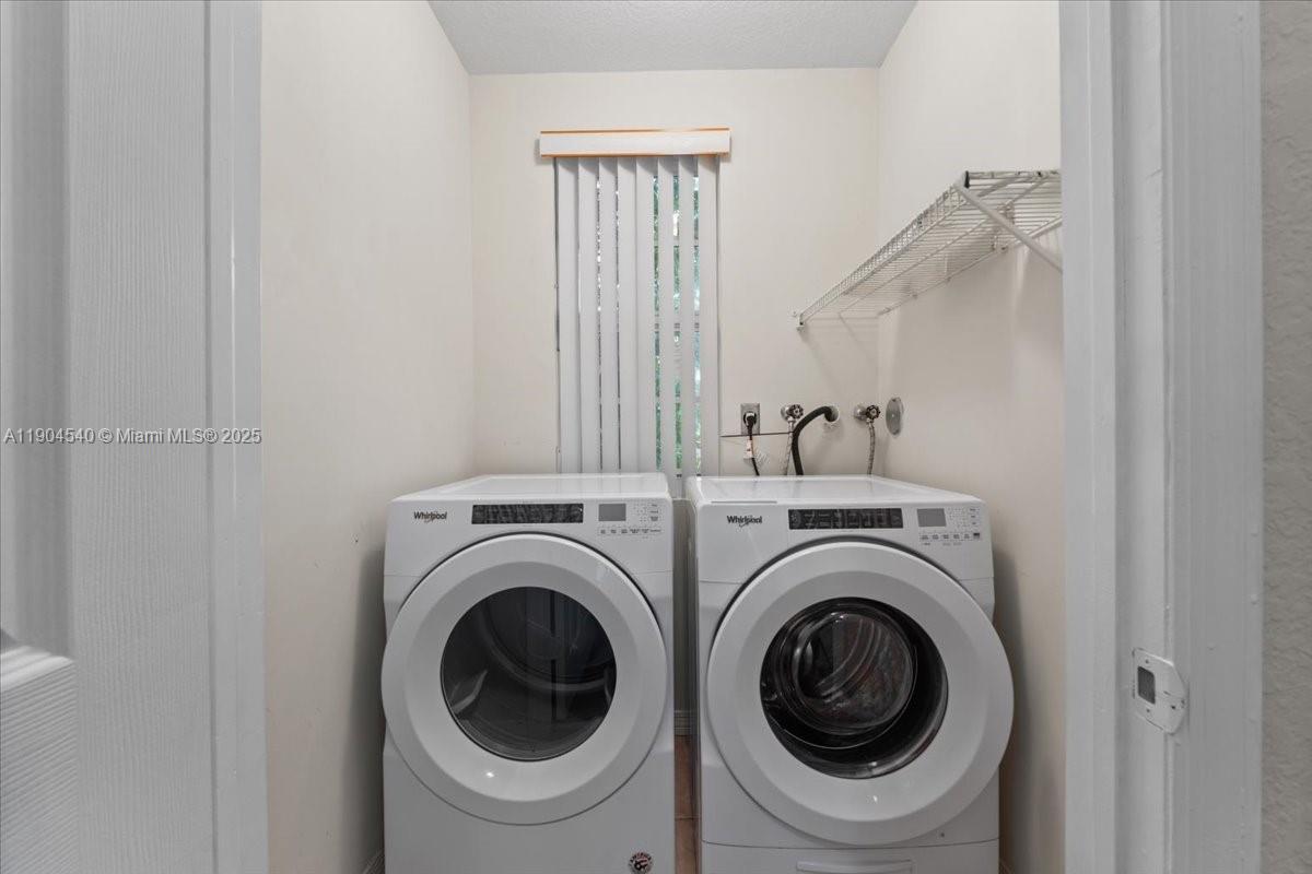 12720 Southwest 49th Court Miramar, FL 33027 - Photo 18 of 26 a view of a hallway with washer and dryer