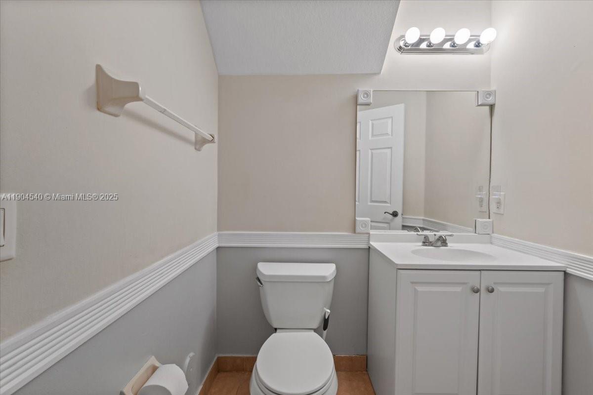 12720 Southwest 49th Court Miramar, FL 33027 - Photo 19 of 26 a bathroom with a toilet sink and mirror