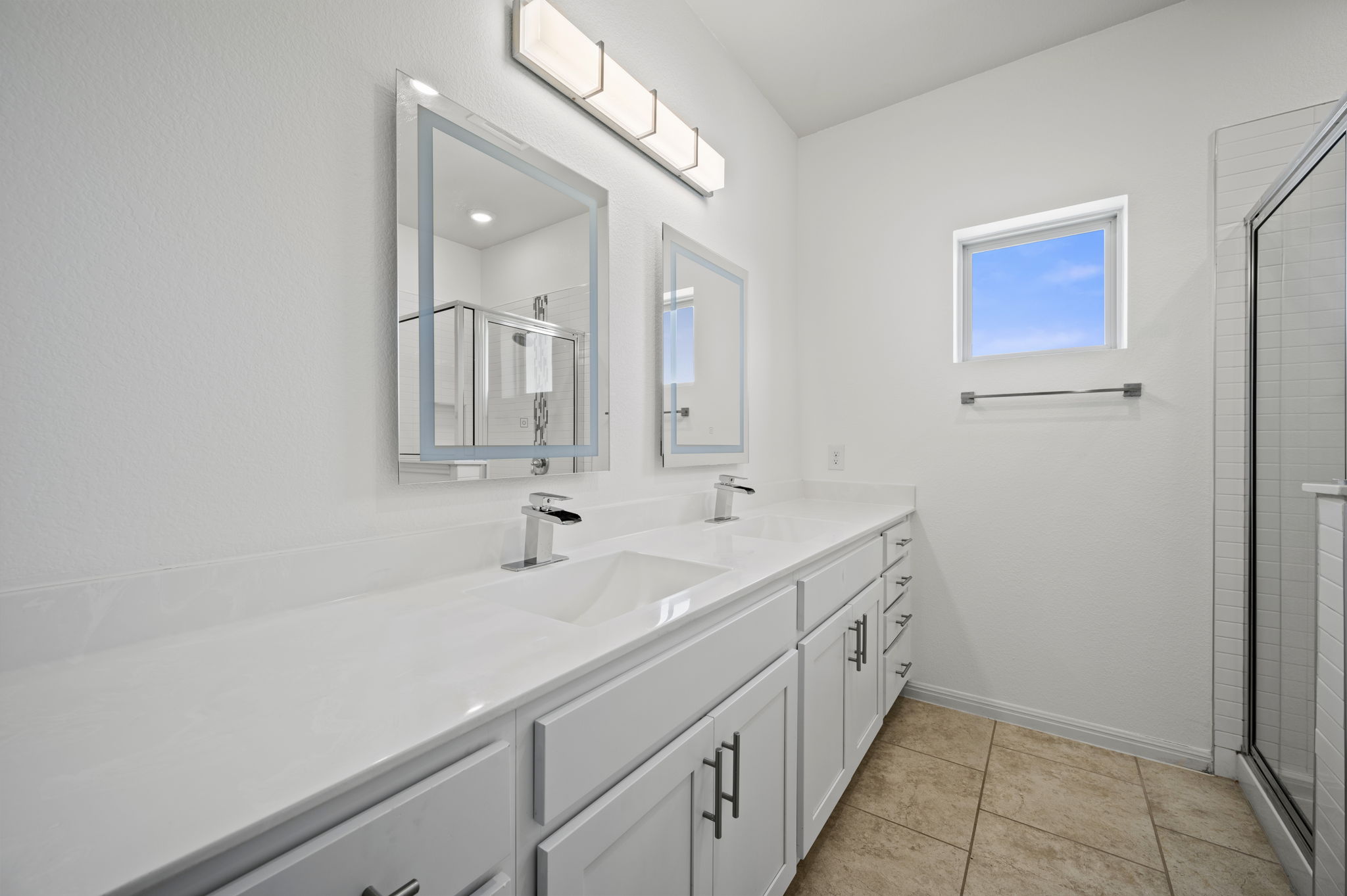 5809 Charles Merle Dr., Unit B Austin, TX 78747 - Photo 13 of 27 Full bath with a sink, double vanity, a shower stall, and tile patterned floors