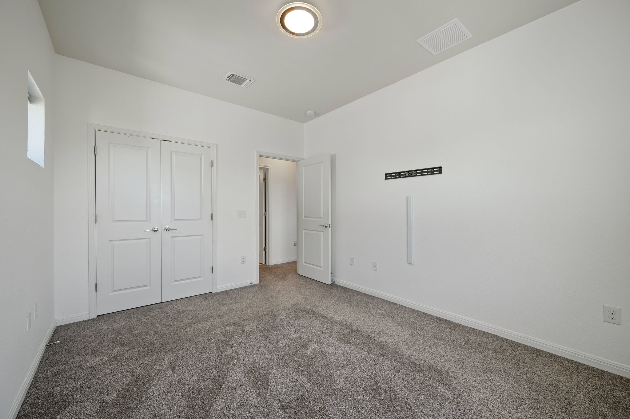 5809 Charles Merle Dr., Unit B Austin, TX 78747 - Photo 15 of 27 Unfurnished bedroom with visible vents, carpet flooring, and baseboards