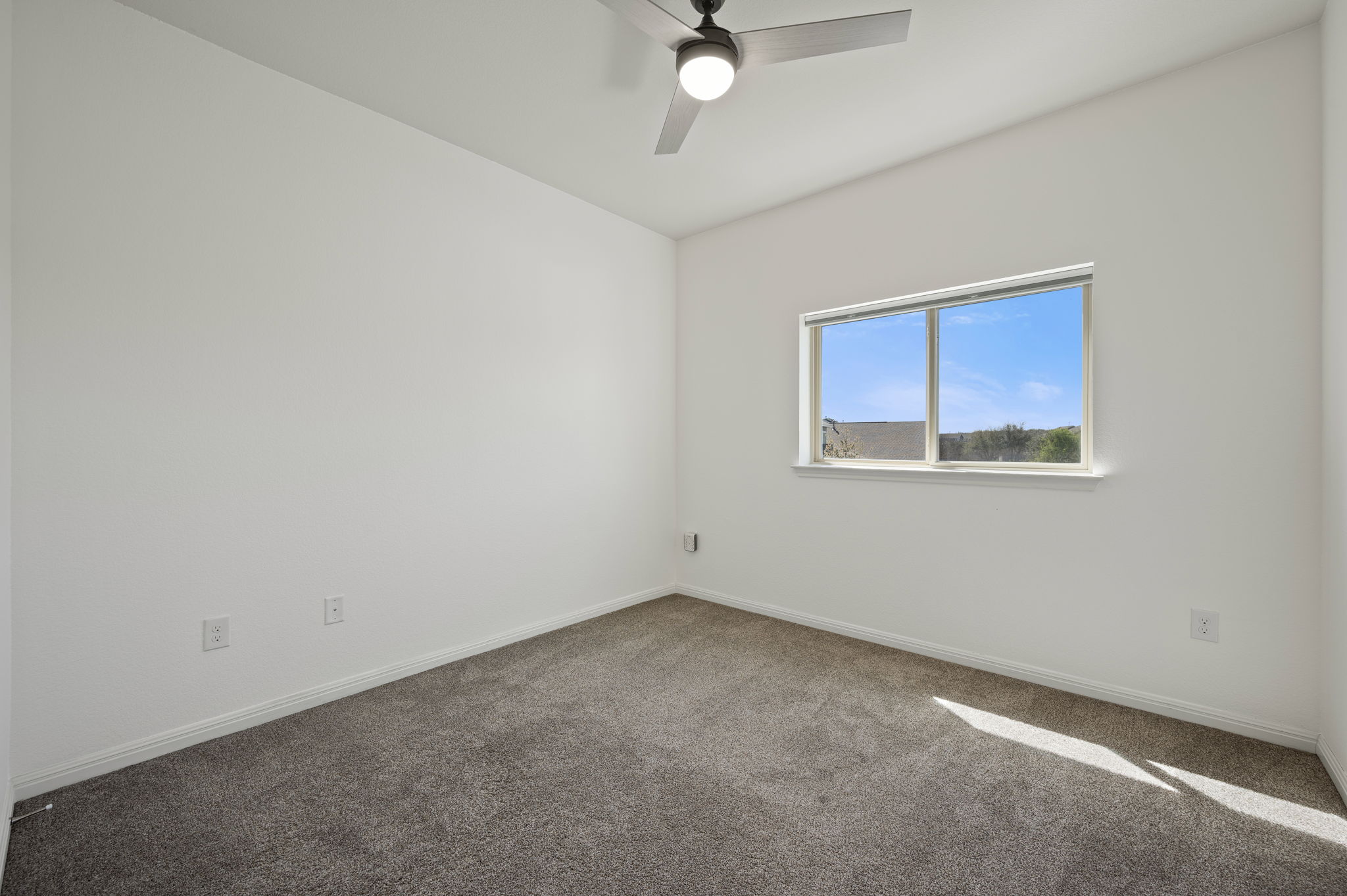 5809 Charles Merle Dr., Unit B Austin, TX 78747 - Photo 17 of 27 Empty room featuring carpet flooring, baseboards, and ceiling fan