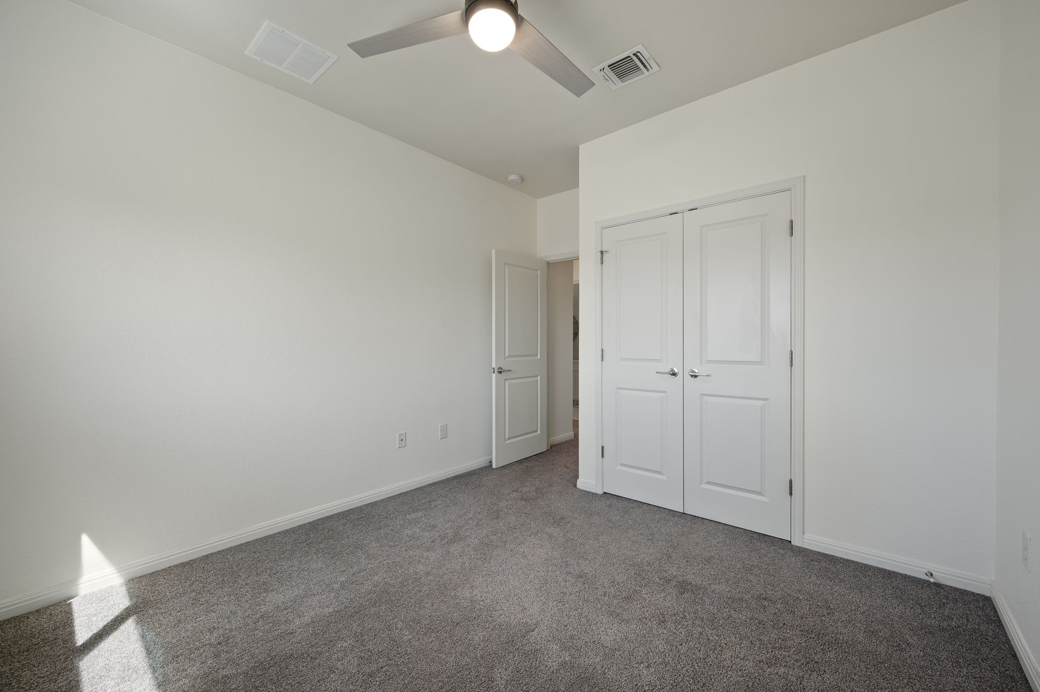 5809 Charles Merle Dr., Unit B Austin, TX 78747 - Photo 18 of 27 Unfurnished bedroom with a closet, visible vents, carpet flooring, and baseboards