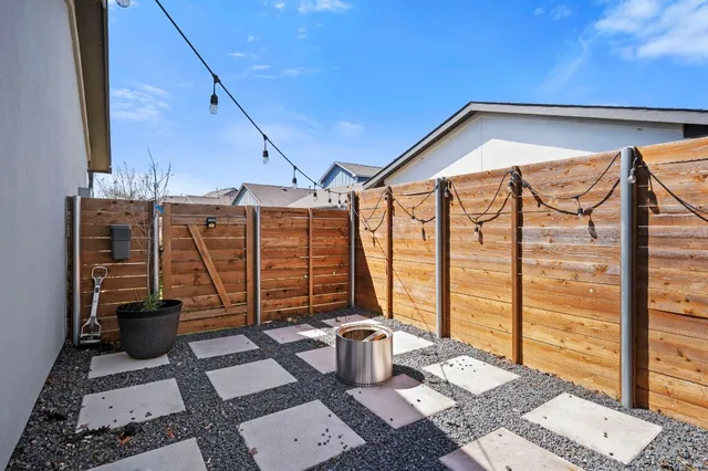 a swimming pool with outdoor seating and yard