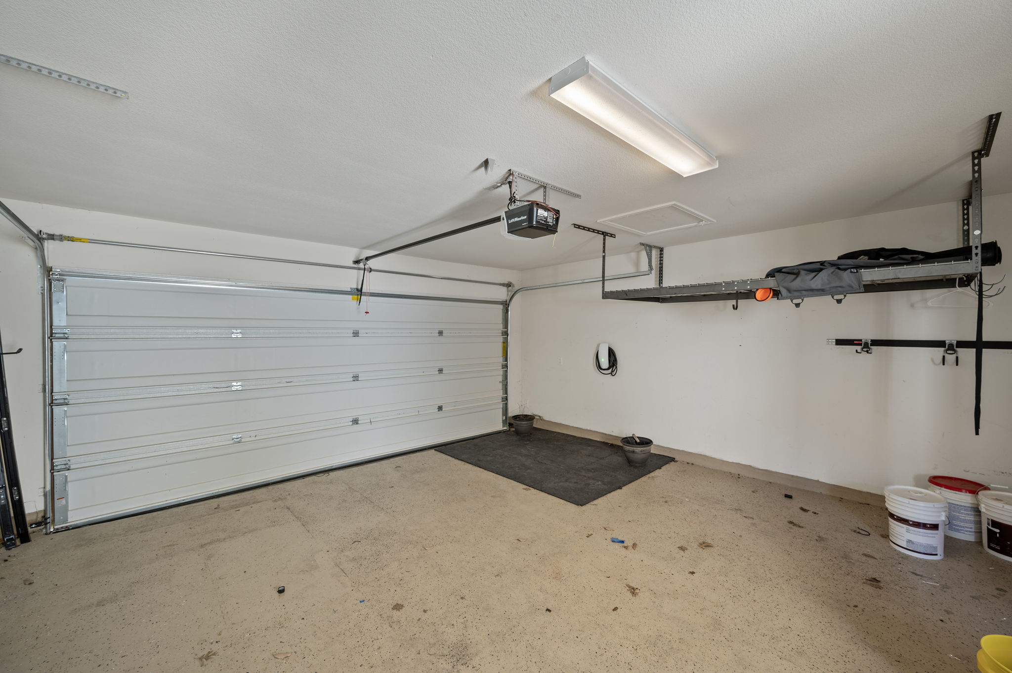5809 Charles Merle Dr., Unit B Austin, TX 78747 - Photo 23 of 27 Garage featuring a garage door opener