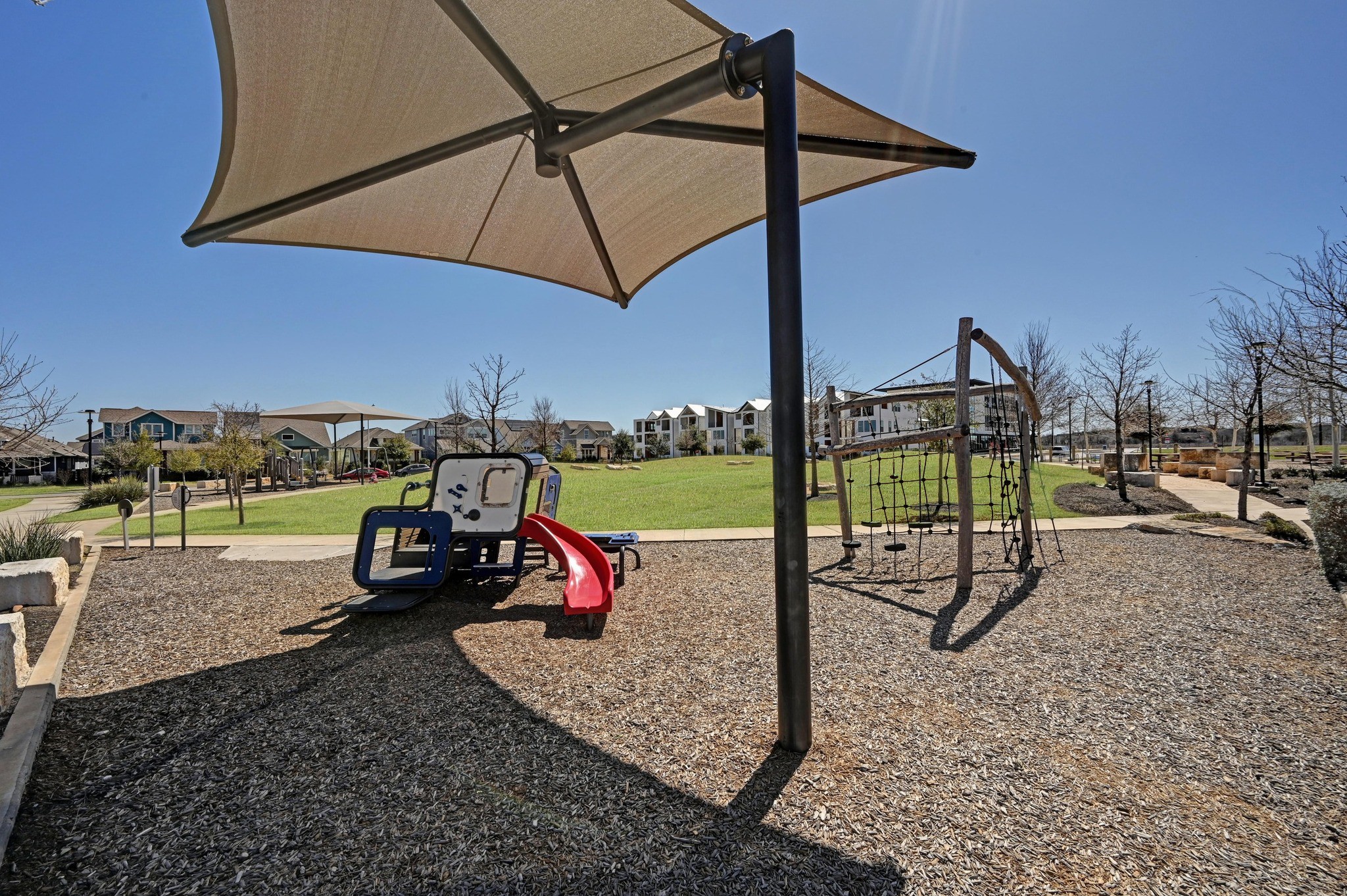 5809 Charles Merle Dr., Unit B Austin, TX 78747 - Photo 24 of 27 Community playground with a residential view and a lawn