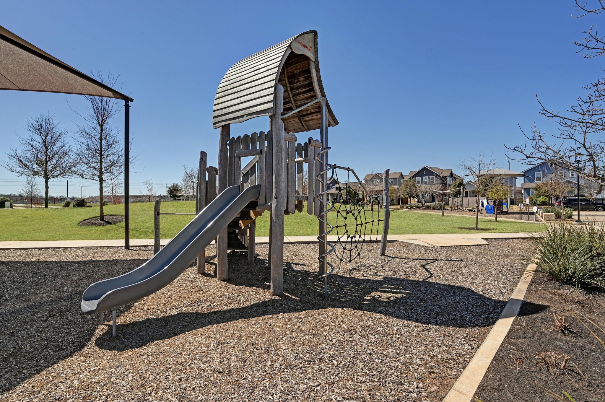 5809 Charles Merle Dr., Unit B Austin, TX 78747 - Photo 25 of 27 Community playground with a residential view and a lawn
