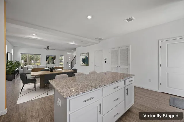 a kitchen with sink a microwave and cabinets