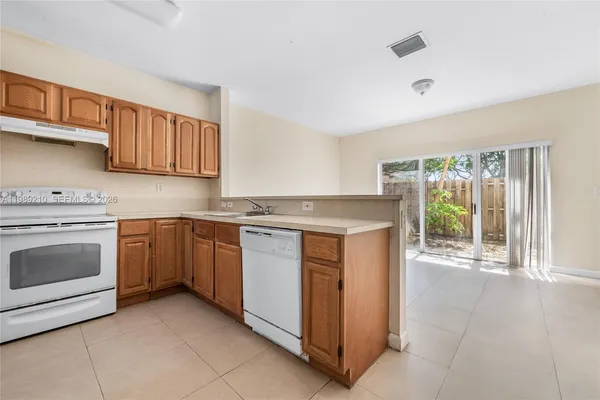 a kitchen with a stove top oven sink and cabinets