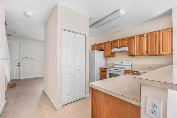 a utility room with cabinets washer and dryer