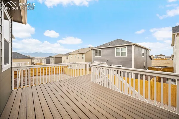 a view of a wooden deck with a yard