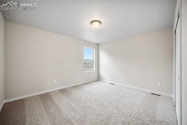 a view of an empty room and a window