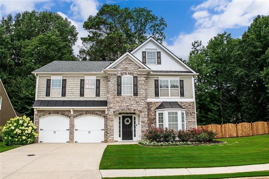 3395 The Commons Drive Cumming, GA 30041 - Photo 1 of 1 a front view of a house with a yard and trees