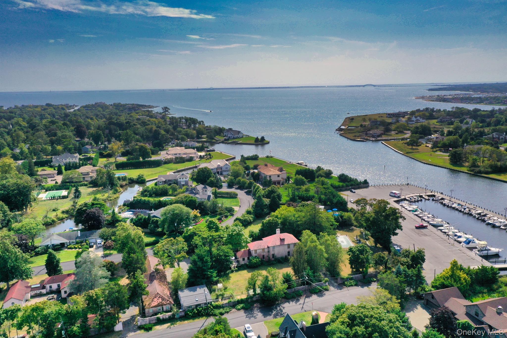 Aerial overview of property's location with a large body of water and a marina