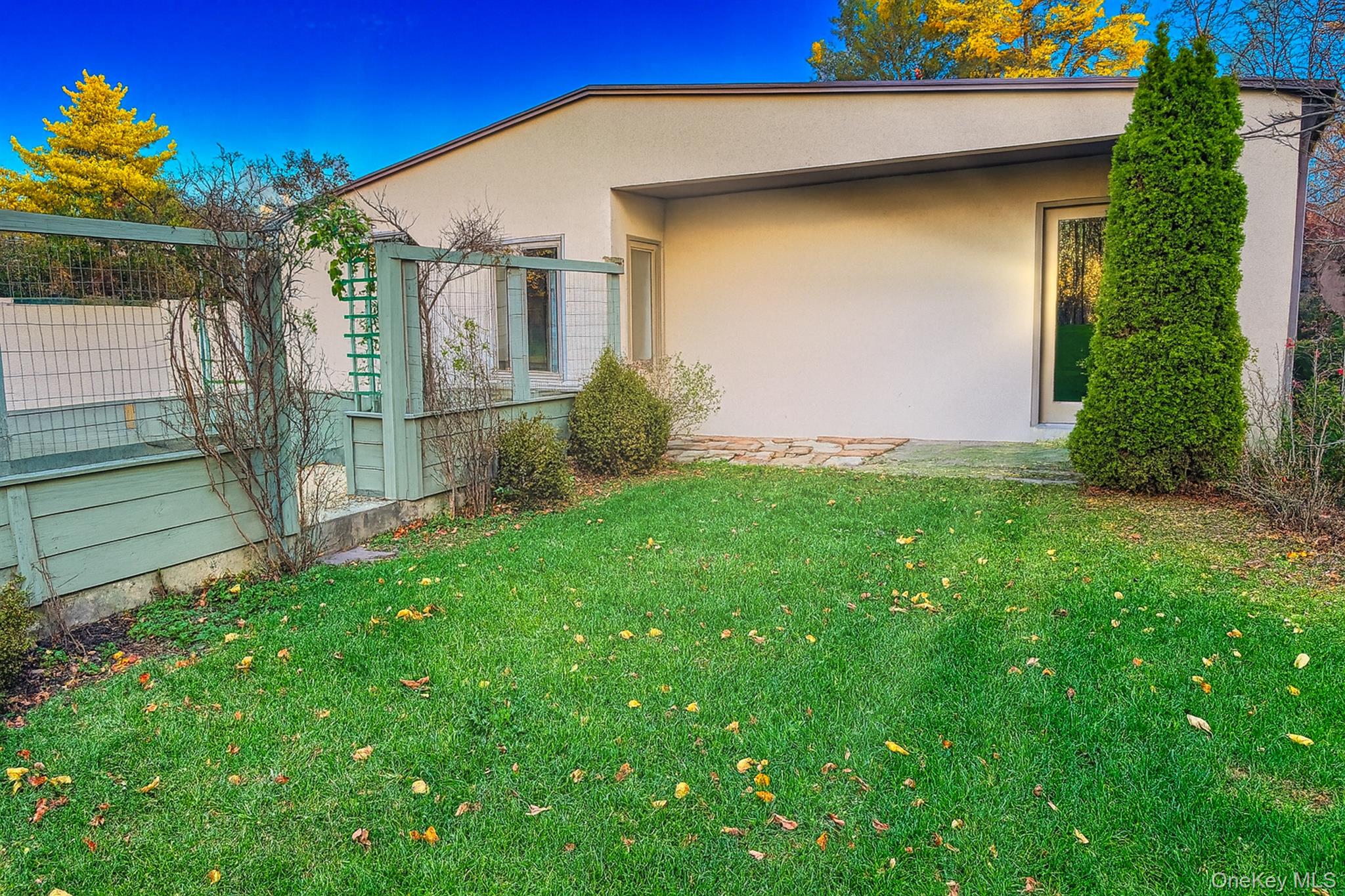 34 Maple Street Islip, NY 11751 - Photo 2 of 10 View of property exterior featuring stucco siding