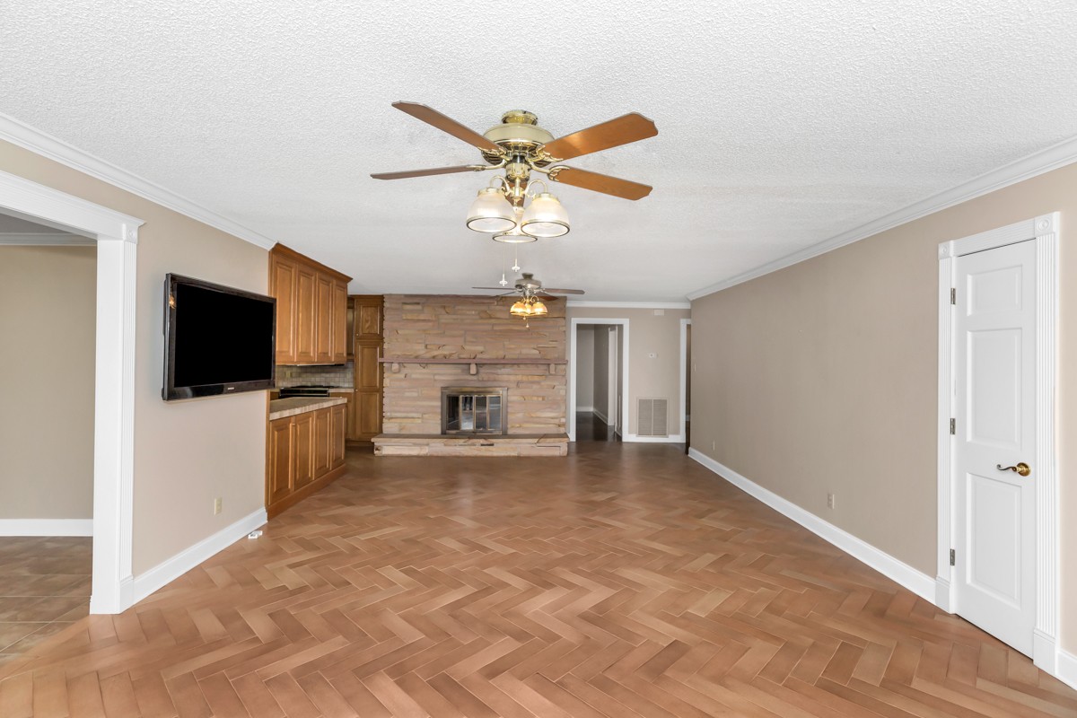 27560 Shannon Road Ardmore, AL 35739 - Photo 5 of 44 a view of a livingroom with a flat screen tv kitchen view and a ceiling fan