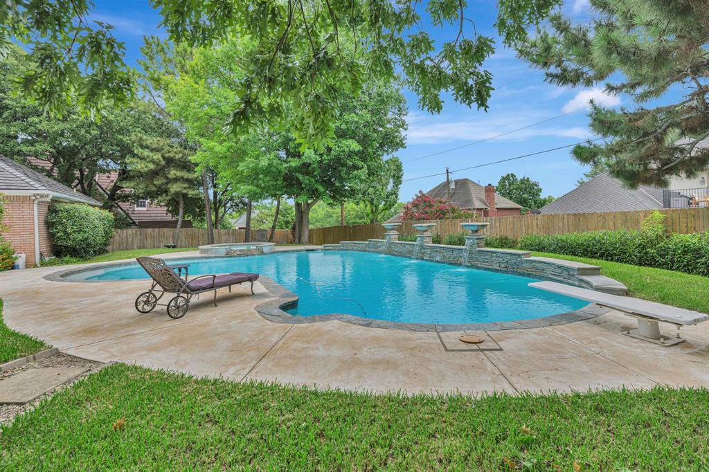 4008 Ramsgate Court Colleyville, TX 76034 - Photo 29 of 33 Expansive swimming pool with concrete decking, a diving board, and integrated spa