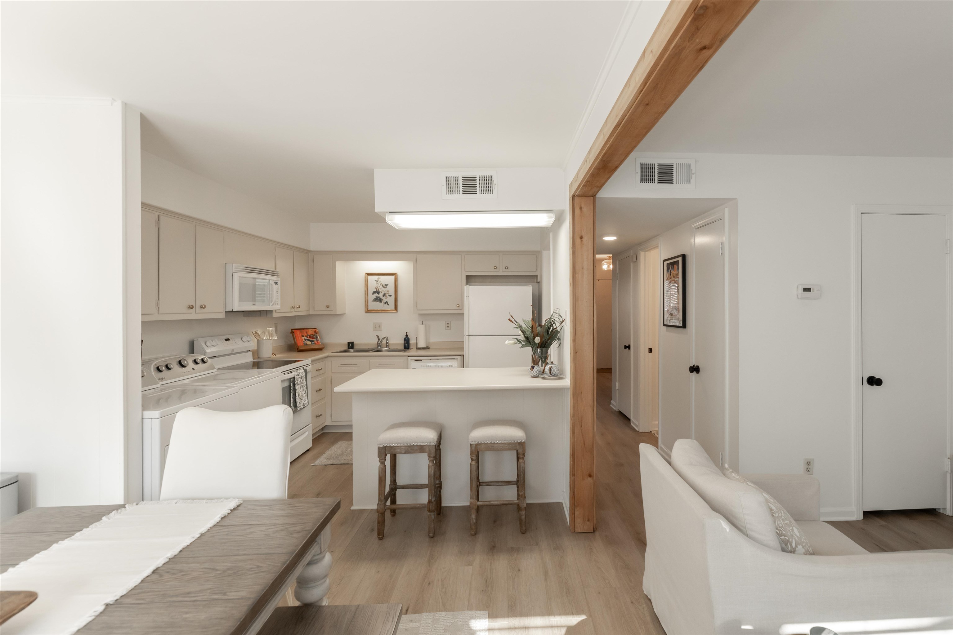 871 South Yates Road, Unit 2 Memphis, TN 38120 - Photo 8 of 27 Kitchen with light hardwood / wood-style floors, white appliances, and a kitchen peninsula.
