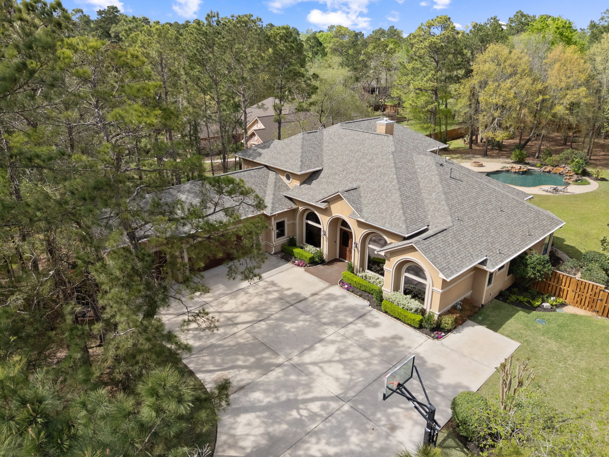 3907 Rayford Road Spring, TX 77386 - Photo 33 of 38 Aerial view showcasing the home’s position on a beautifully wooded 1+ acre homesite, with a wide driveway with extra parking, mature trees, and a private setting.