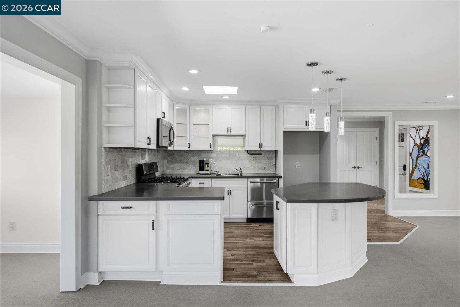 2741 Golden Rain Road, Unit 7 Walnut Creek, CA 94595 - Photo 13 of 60 a large kitchen with stainless steel appliances granite countertop a stove a sink a refrigerator and white cabinets with wooden floor