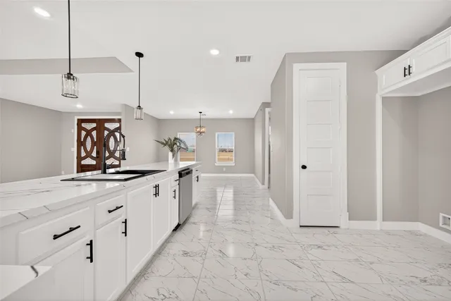 a kitchen with a sink and cabinets