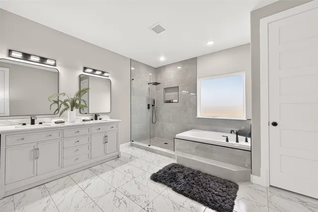 a bathroom with a bathtub sink and mirror