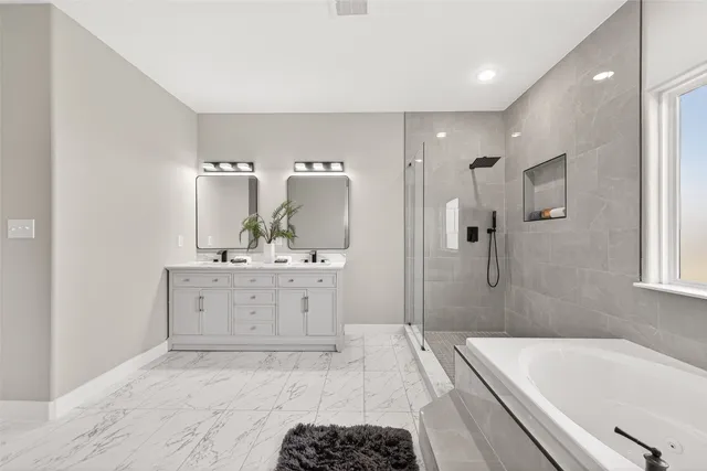 a bathroom with a tub sink and mirror