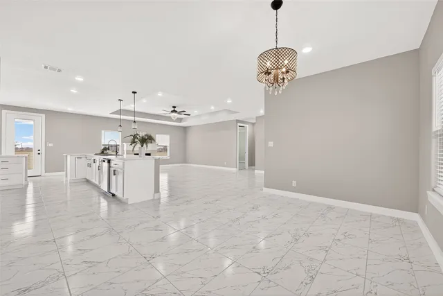 a view of a kitchen with furniture and stainless steel appliances