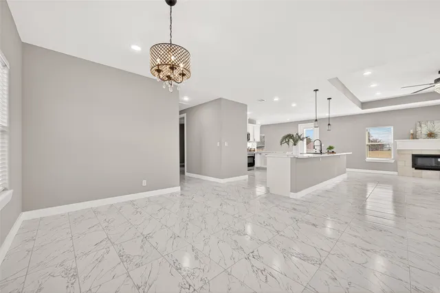 a view of a kitchen with a sink and chandelier