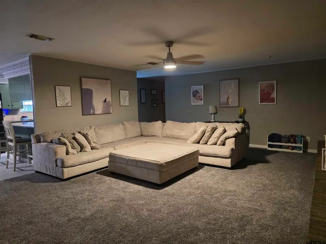a living room with furniture and a chandelier